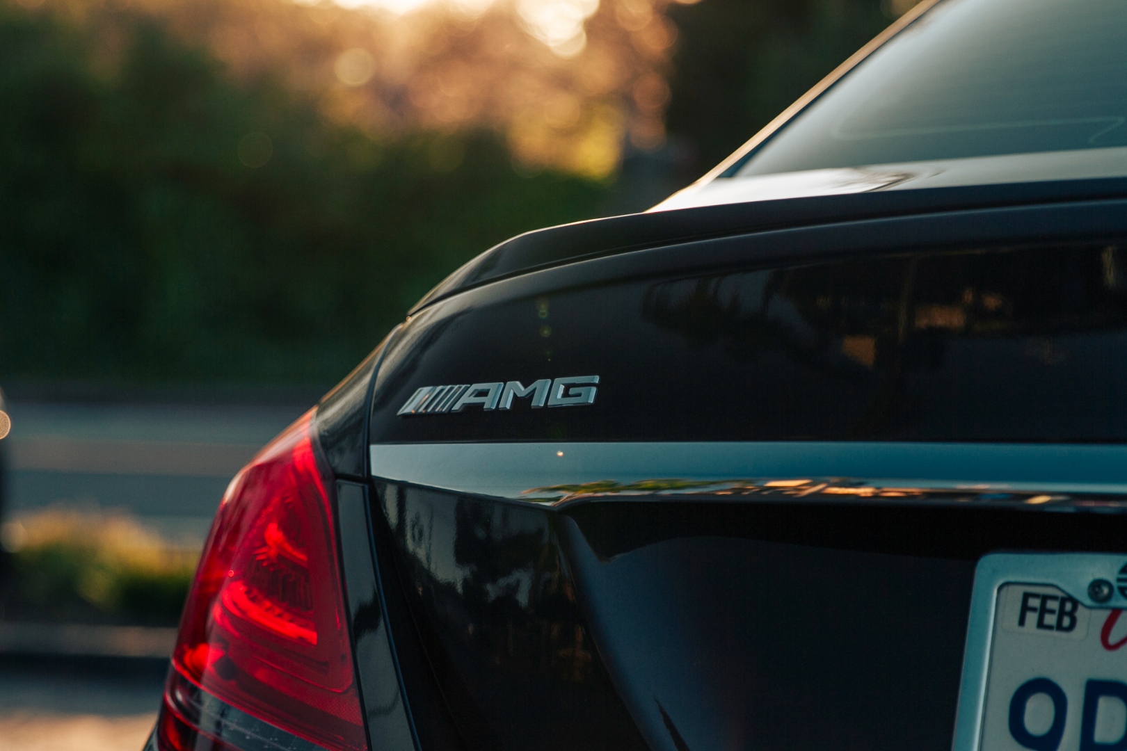 Porsche 992 taillights on freeway at sunset