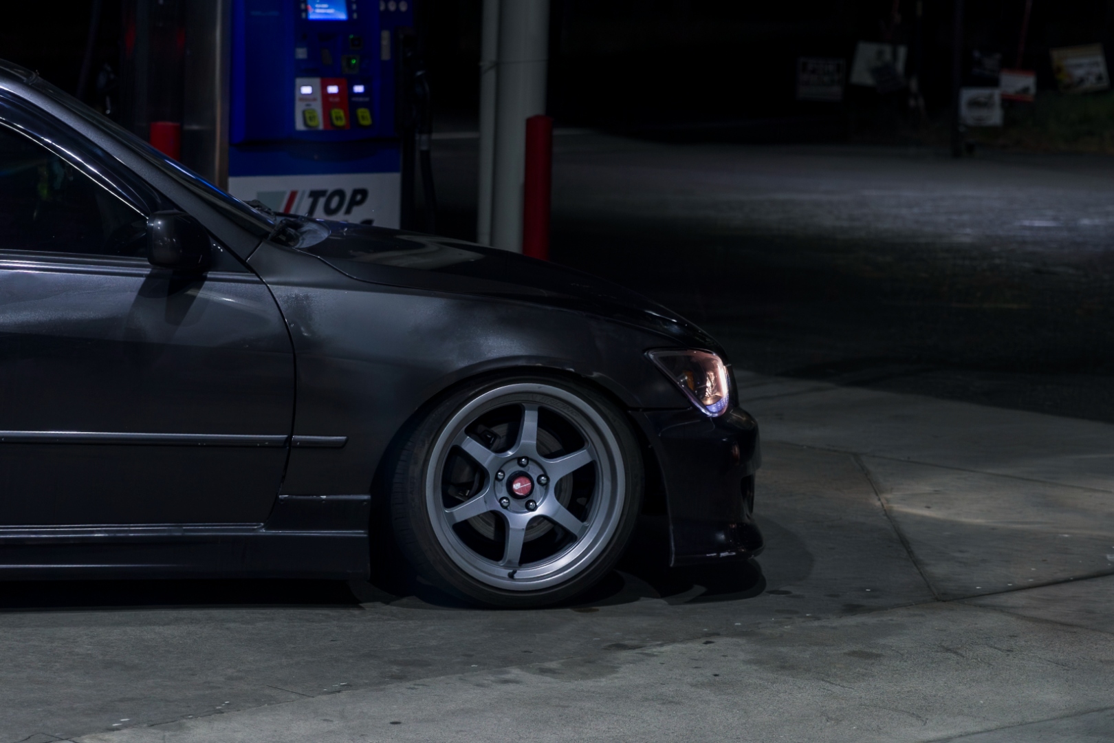 Lexus IS300 rear three-quarter at gas station