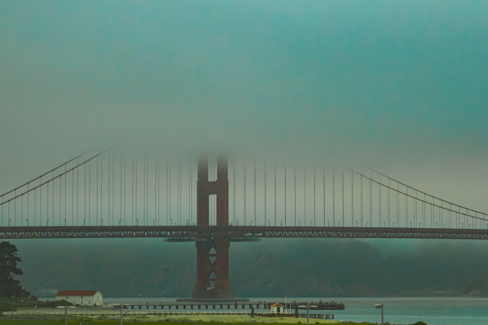 Golden Gate Bridge in morning teal fog