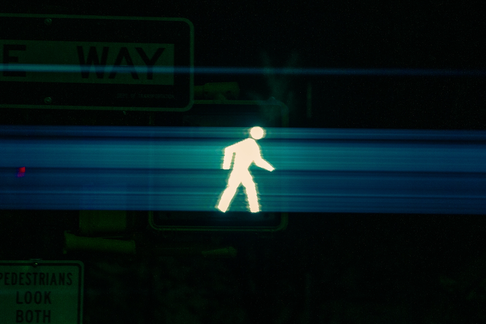 NYC walk signal with blue light trails at night