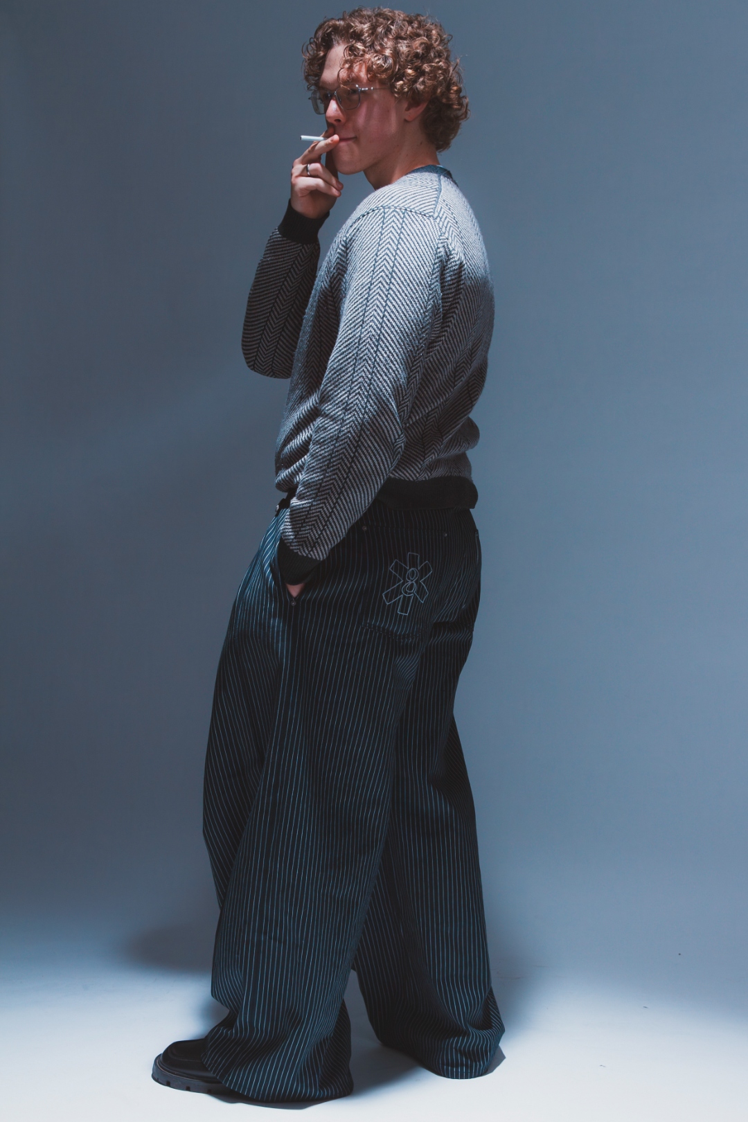 Self-portrait: looking down, candid moment adjusting belt