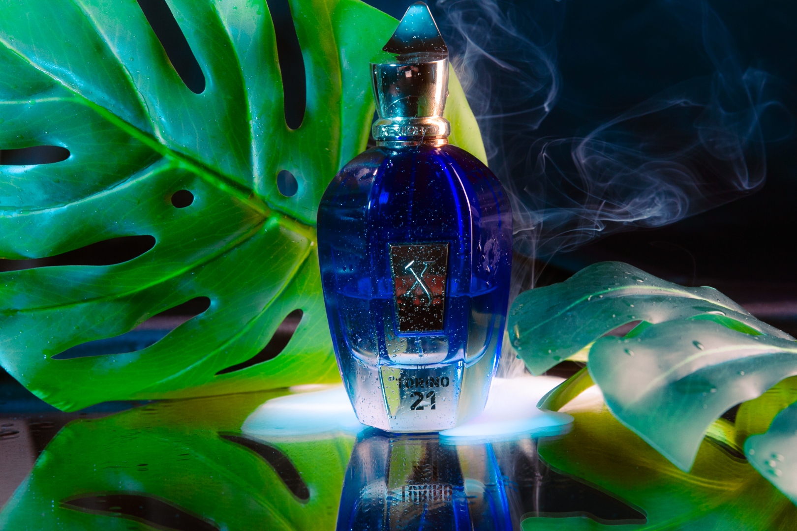 Xerjoff Torino 21 perfume bottle with smoke and monstera leaves on dark background