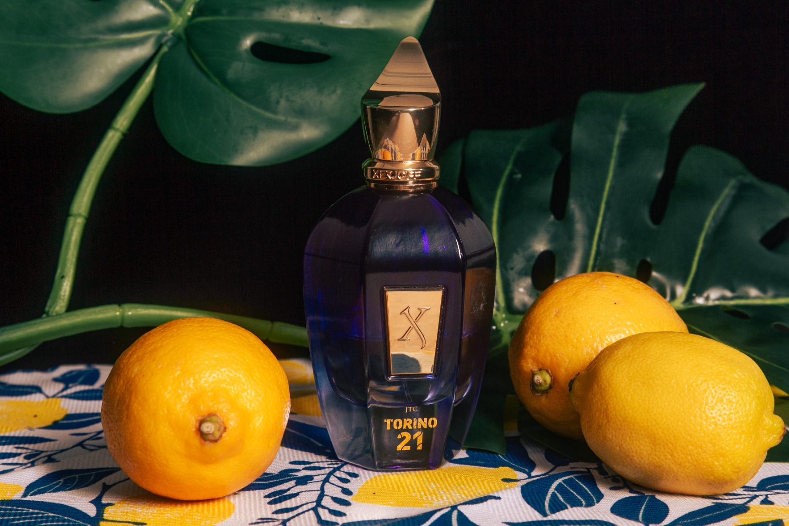 Xerjoff Torino 21 perfume bottle with lemons and tropical leaves