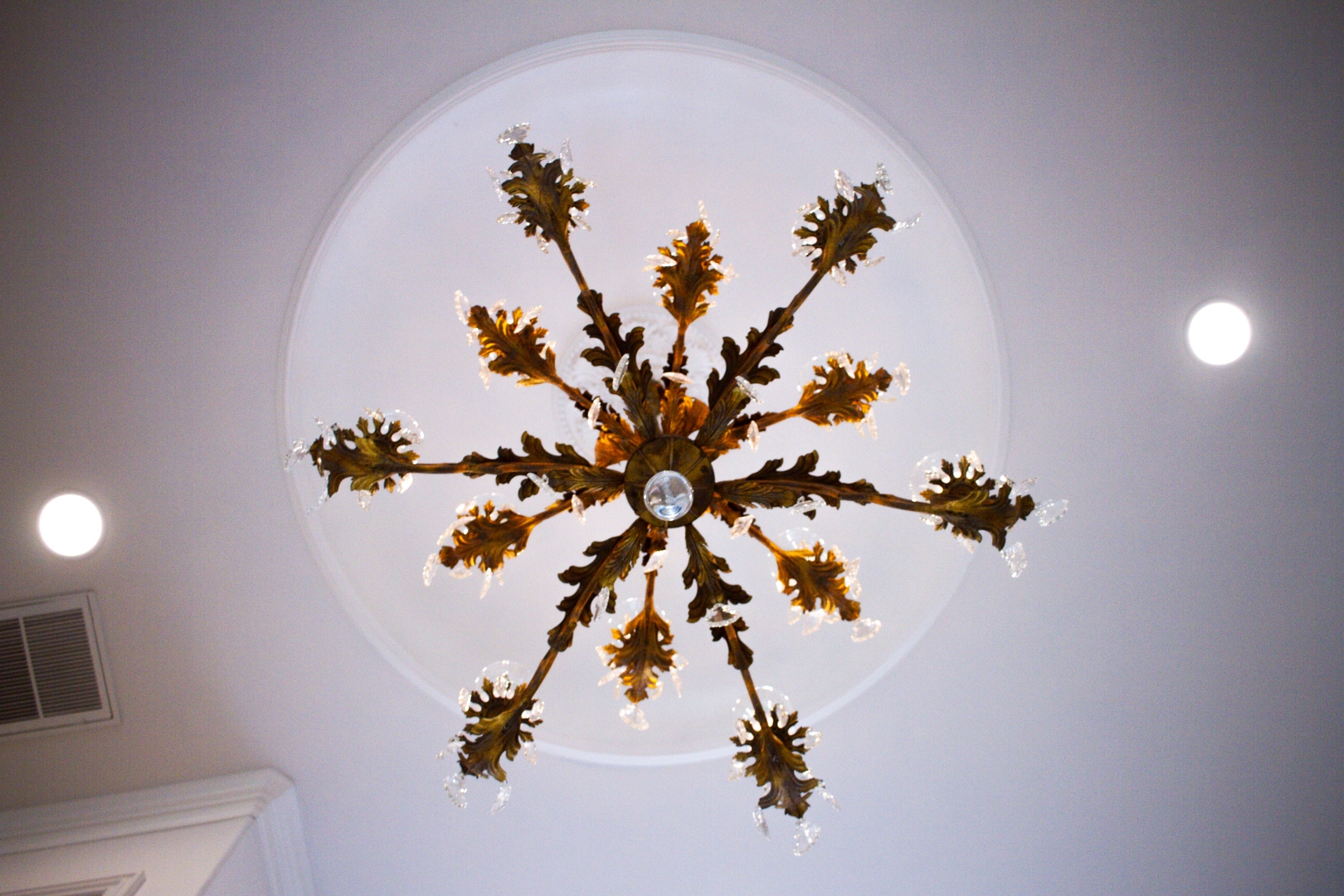 Crystal chandelier viewed from below through circular ceiling
