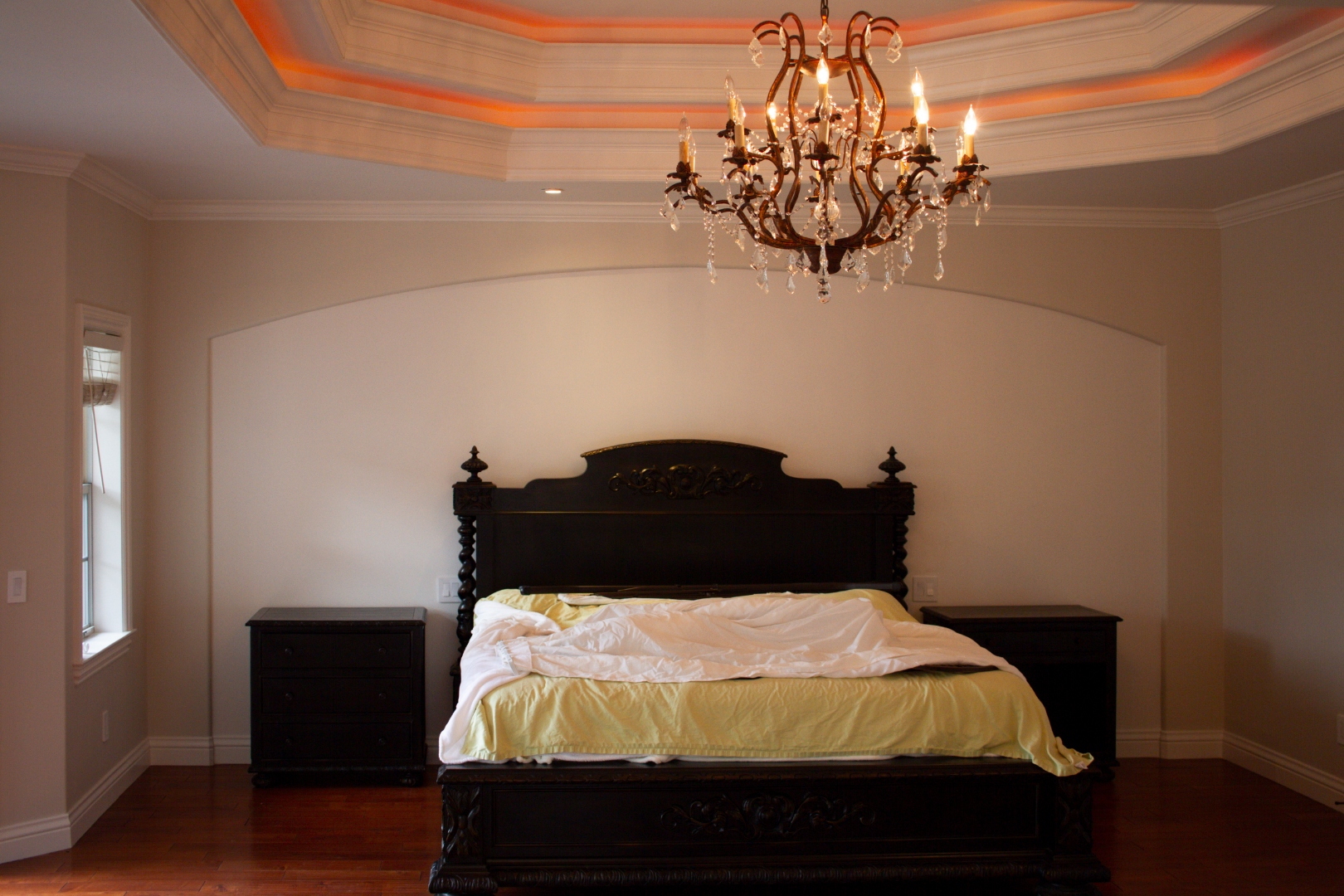 Master bedroom with tray ceiling and crystal chandelier