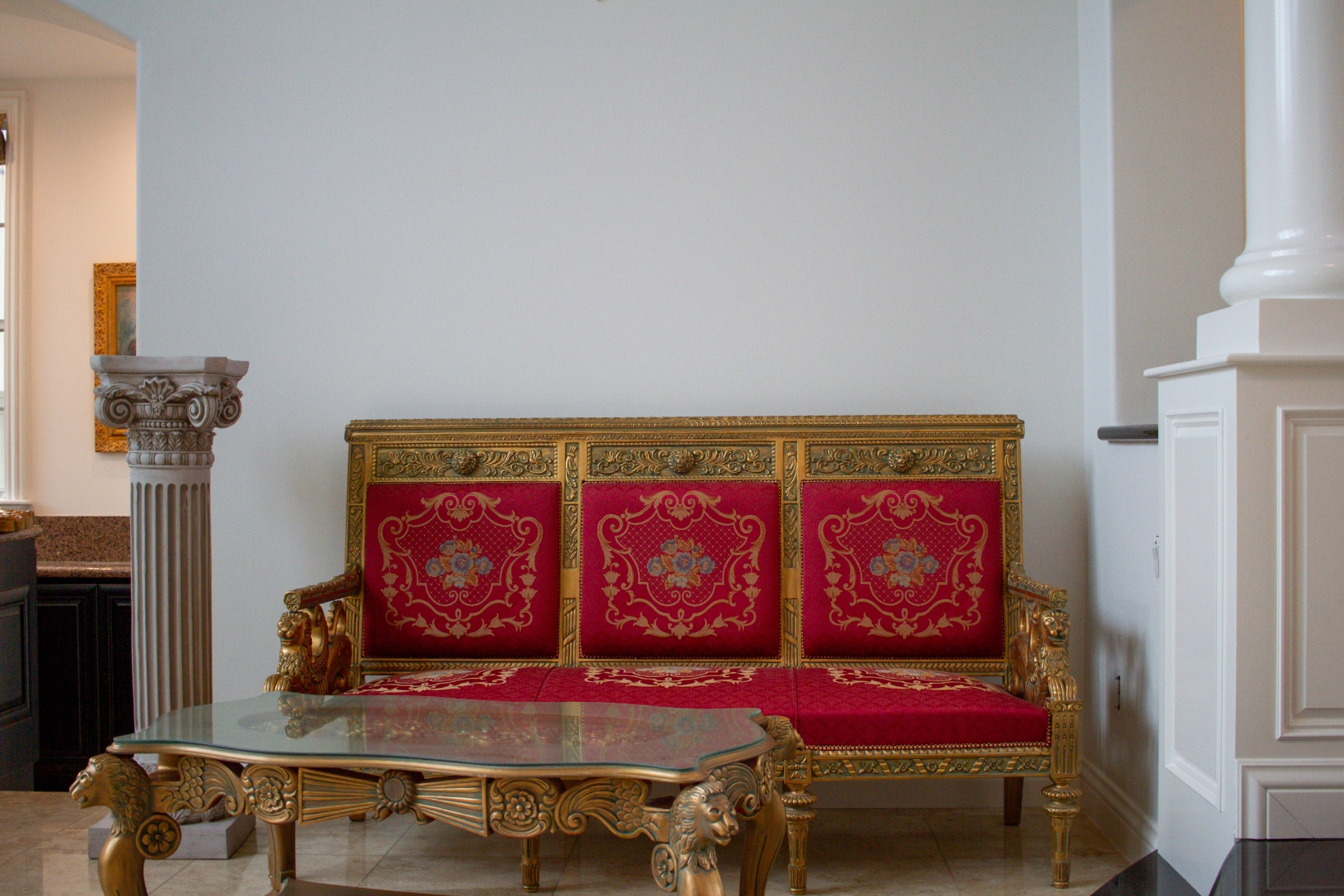 Ornate red and gold French settee, wide angle with columns
