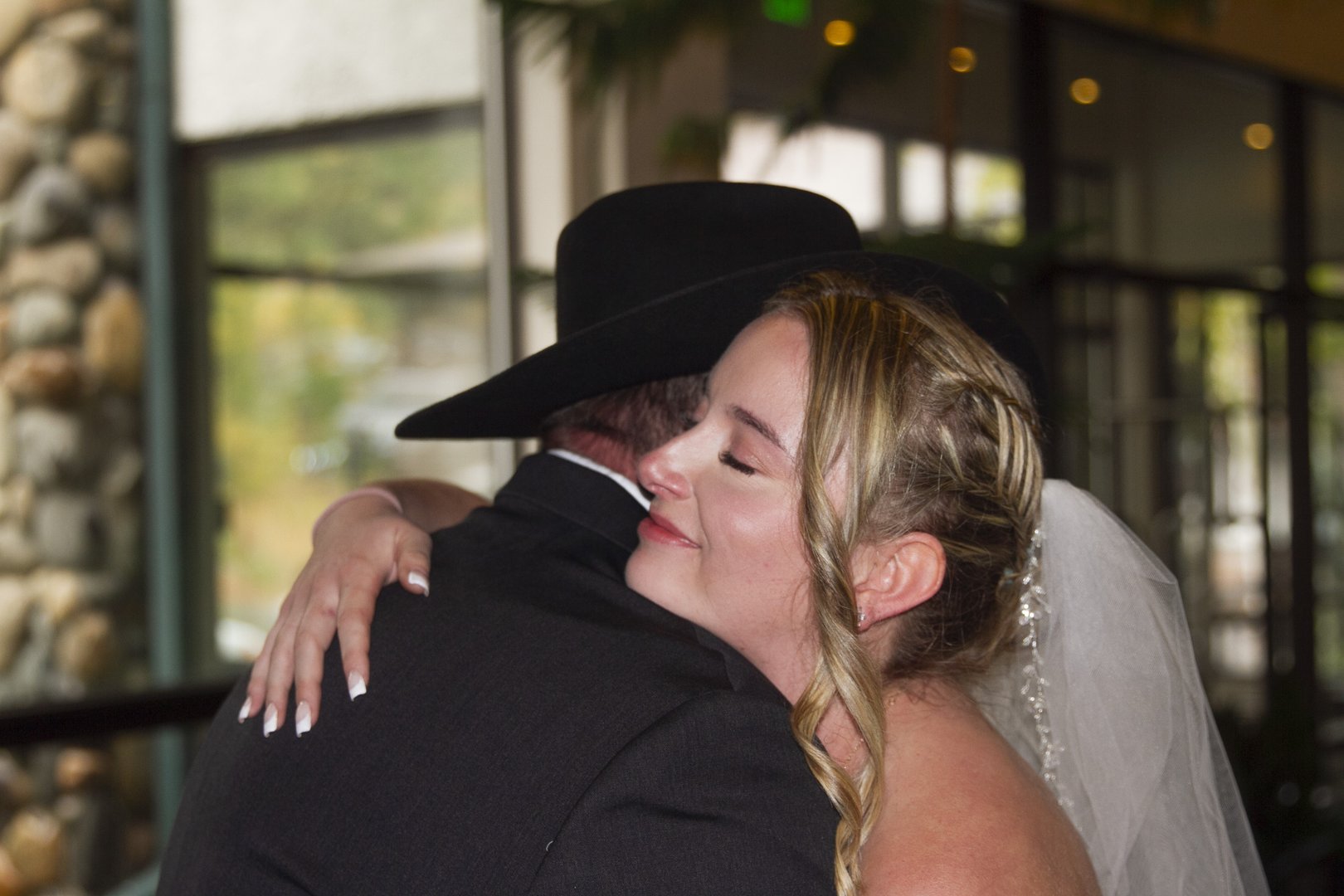 Bride embracing a loved one after her ceremony, photographed by Kieran Bishop