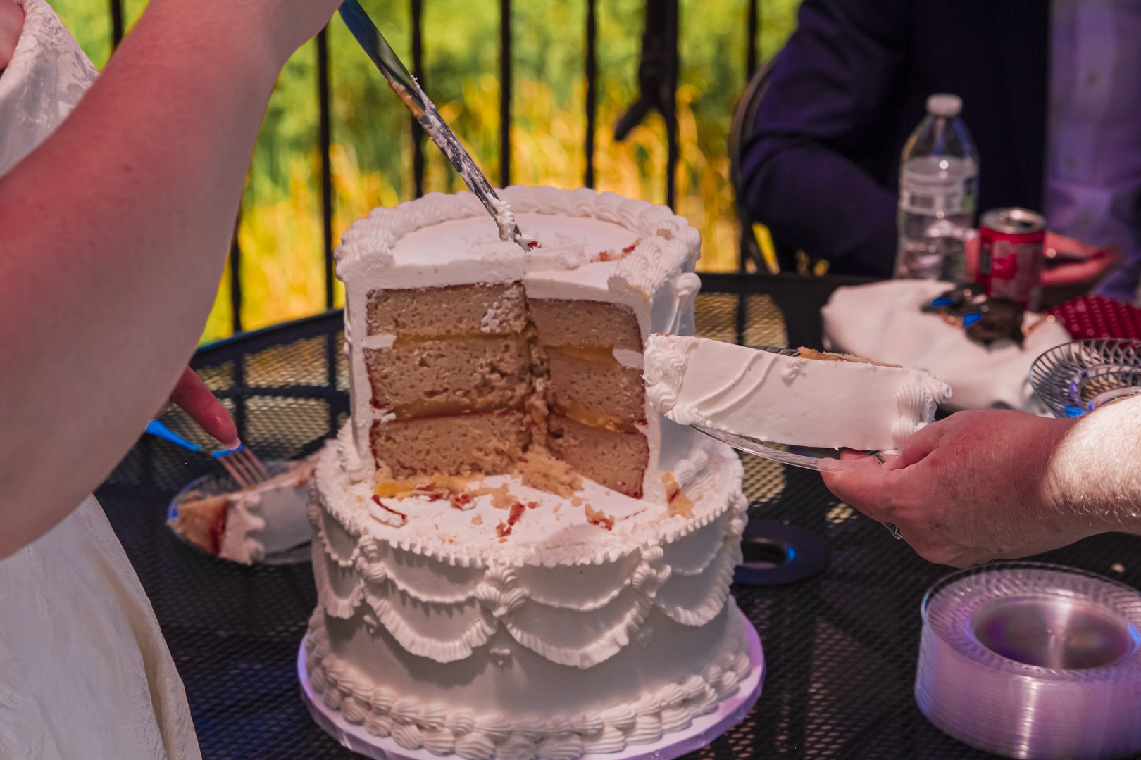 Close up of the couple cutting a two tier white wedding cake